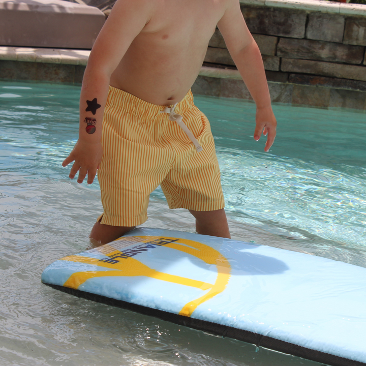 Boys Stretch Swim Sunny Stripe on model playing with board in the pool