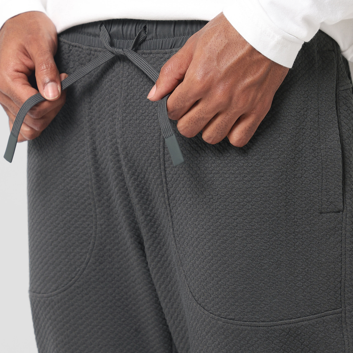 Roam Jogger Coal close up of model tying drawstring