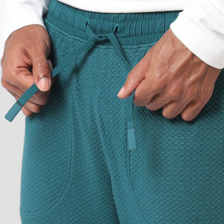 Roam Jogger Dark Teal close up of model tying drawstring