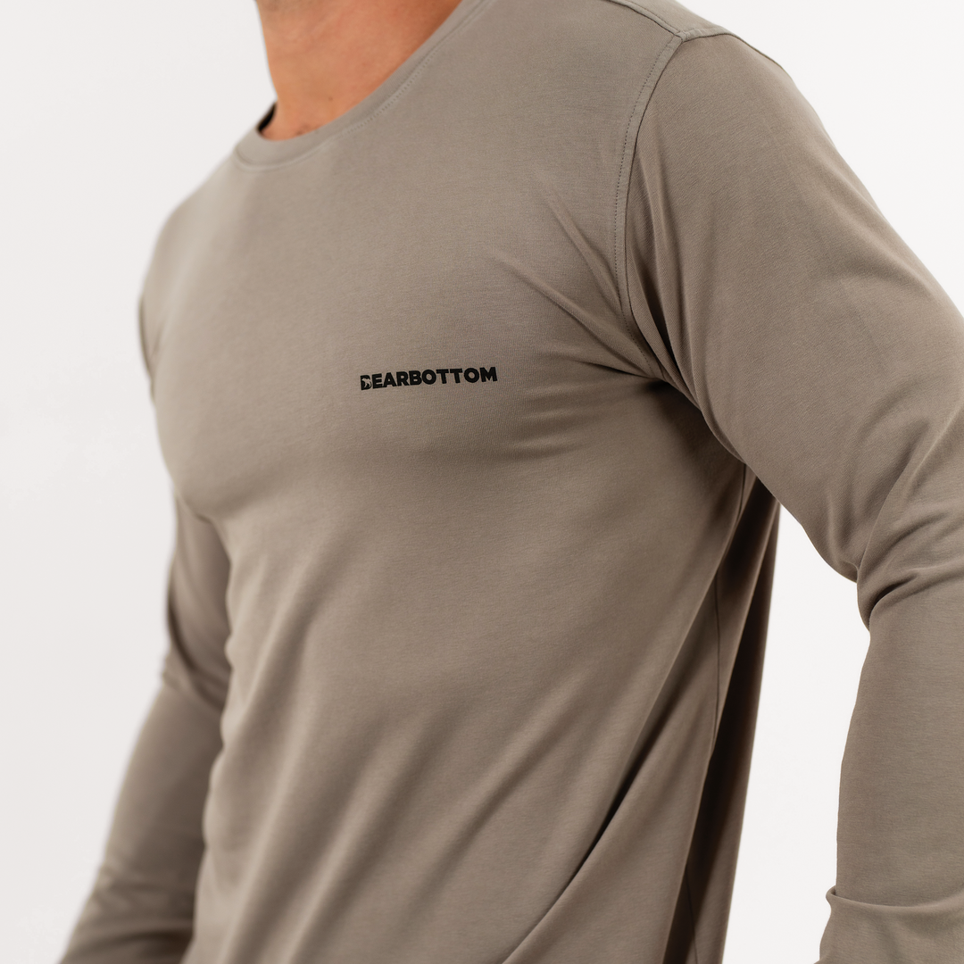 Natural Dye Logo Long Sleeve Tee in Mud brown close up on model of Bearbottom logo on left chest